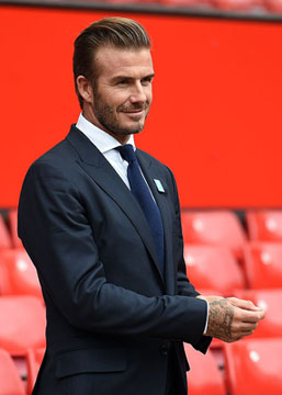 Former Manchester United and England footballer David Beckham poses on the pitch at Old Trafford in Manchester, north west England on October 6, 2015 ahead of a charity football match in aid of UNICEF. Beckham will lead the Great Britain and Ireland team against a Rest of the World team led by Zinedine Zidane at Old Trafford on November 14.  AFP PHOTO/PAUL ELLIS        (Photo credit should read PAUL ELLIS/AFP/Getty Images)