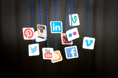 BELCHATOW, POLAND - AUGUST 31, 2014: Popular social media website logos printed on paper and hanging on strings.