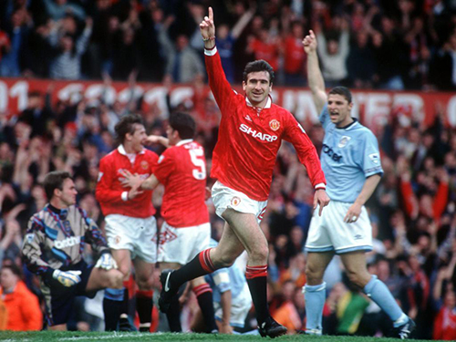 23 APR 1994:  A PICTURE SHOWING ERIC CANTONA OF MANCHESTER UNITED FOOTBALL CLUB AS HE RUNS OFF WITH HIS ARM RAISED IN CELEBRATION AFTER SCORING THE FIRST GOAL IN HIS FIRST GAME AFTER HIS SUSPENSION AGAINST MANCESTER CITY IN THEIR PREMIER LEAGUE MATCH Mandatory Credit: Anton Want/ALLSPORT